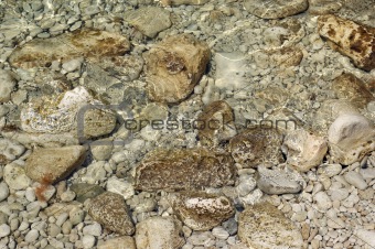pebbles under rippled water