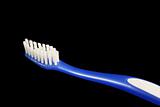 Isolated blue toothbrush on black background