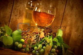 Wine glass with bottle and grapes