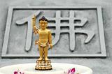 Golden buddha with the background of the chinese character 'budd