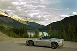 Sports car with mountain lake in the background