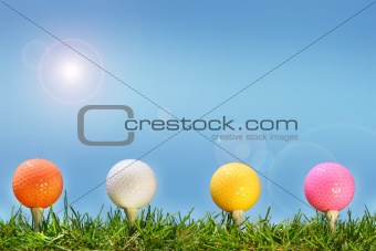 Colored golf balls in the grass