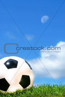 Closeup of a soccerball against a blue sky