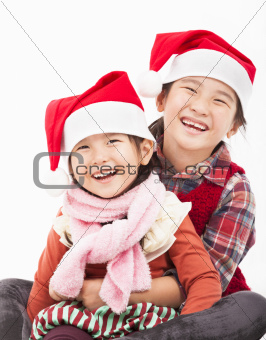Happy girls in christmas hat and sitting together