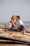 couple sitting on old boat and kiss