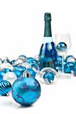Blue Christmas ornaments with a bottle of sparkling wine