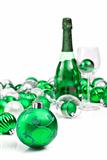 Green christmas ornaments and sparkling wine