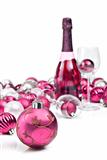Pink christmas ornaments with sparkling wine