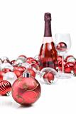 Red christmas ornaments with sparkling wine