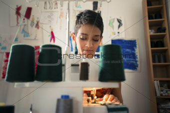 Young woman at work as tailor in fashion design atelier