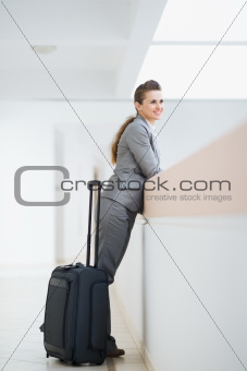 Business woman in business trip with wheel bag