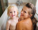 Portrait of mother and baby taking bath