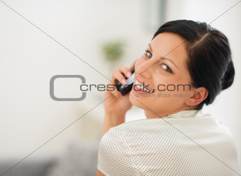 Portrait of happy young woman speaking cellphone