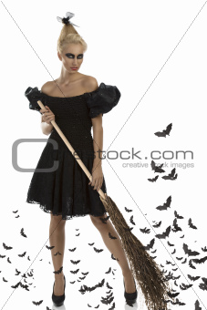 sexy girl in halloween suit with besom in all hands