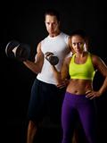 Couple doing dumbbell lifts