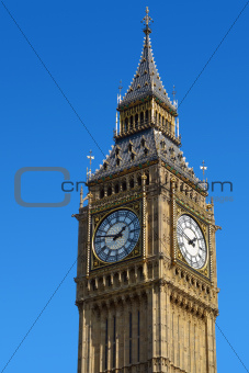 Big Ben Westminster Clock Tower in London with a blue sky.