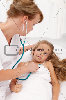 Sick girl examined by female doctor