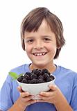 Happy boy with blackberries