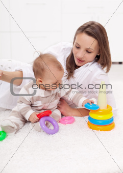 Young woman with baby girl playing