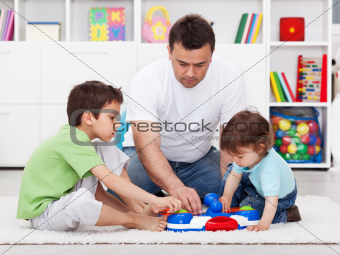 Father showing his sons a new toy