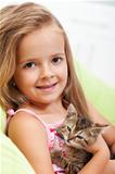 Little girl holding her kitten