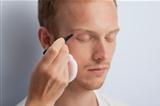 Man's facial cosmetic treatment.
