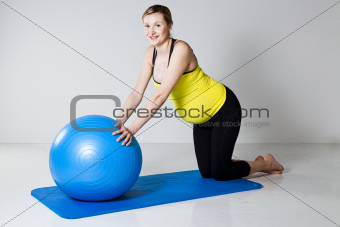Pregnant woman exercising with fitness ball