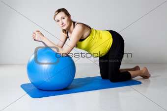 Pregnant woman exercising with fitness ball