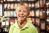 Excited Boy Standing In Sweet Shop