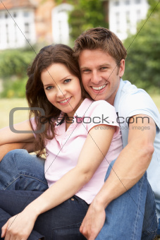 Affectionate Couple Relaxing At Home In Garden Together