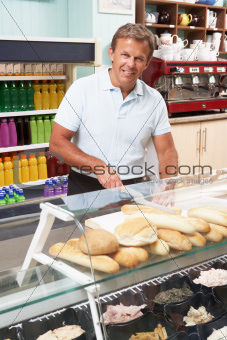 Man Working Behind Counter In Caf