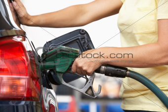 Detail Of Female Motorist Filling Car With Petrol At Petrol Station