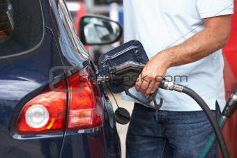 Detail Of Male Motorist Filling Car With Diesel At Petrol Station