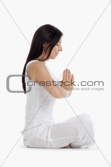 woman sitting on the floor exercising yoga - isolated on white
