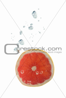 Grapefruit in water with air bubbles