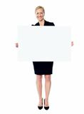 Female business promoter holding white blank banner ad