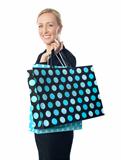 Senior woman posing with dotted shopping bag