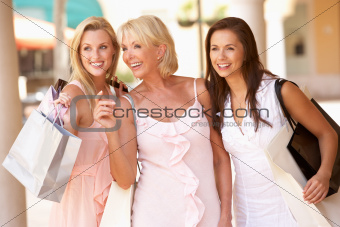 Senior Mother And Daughters Enjoying Shopping Trip Together