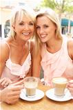 Two Women Enjoying Cup Of Coffee In Caf