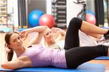 Women Doing Stretching Exercises In Gym