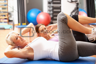 Women Doing Stretching Exercises In Gym