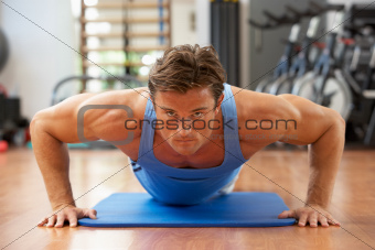 Man Doing Press Ups In Gym