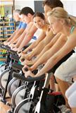 Woman Cycling In Spinning Class In Gym