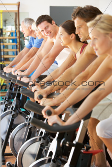 Man Cycling In Spinning Class In Gym