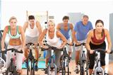 Group Of People In Spinning Class In Gym
