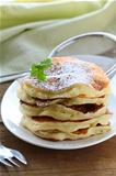 traditional American pancakes on a plate with powdered sugar