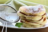 traditional American pancakes on a plate with powdered sugar
