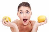 Surprised woman holding two apples