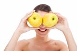 woman holding apples over her eyes 
