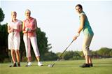 Group Of Female Golfers Teeing Off On Golf Course